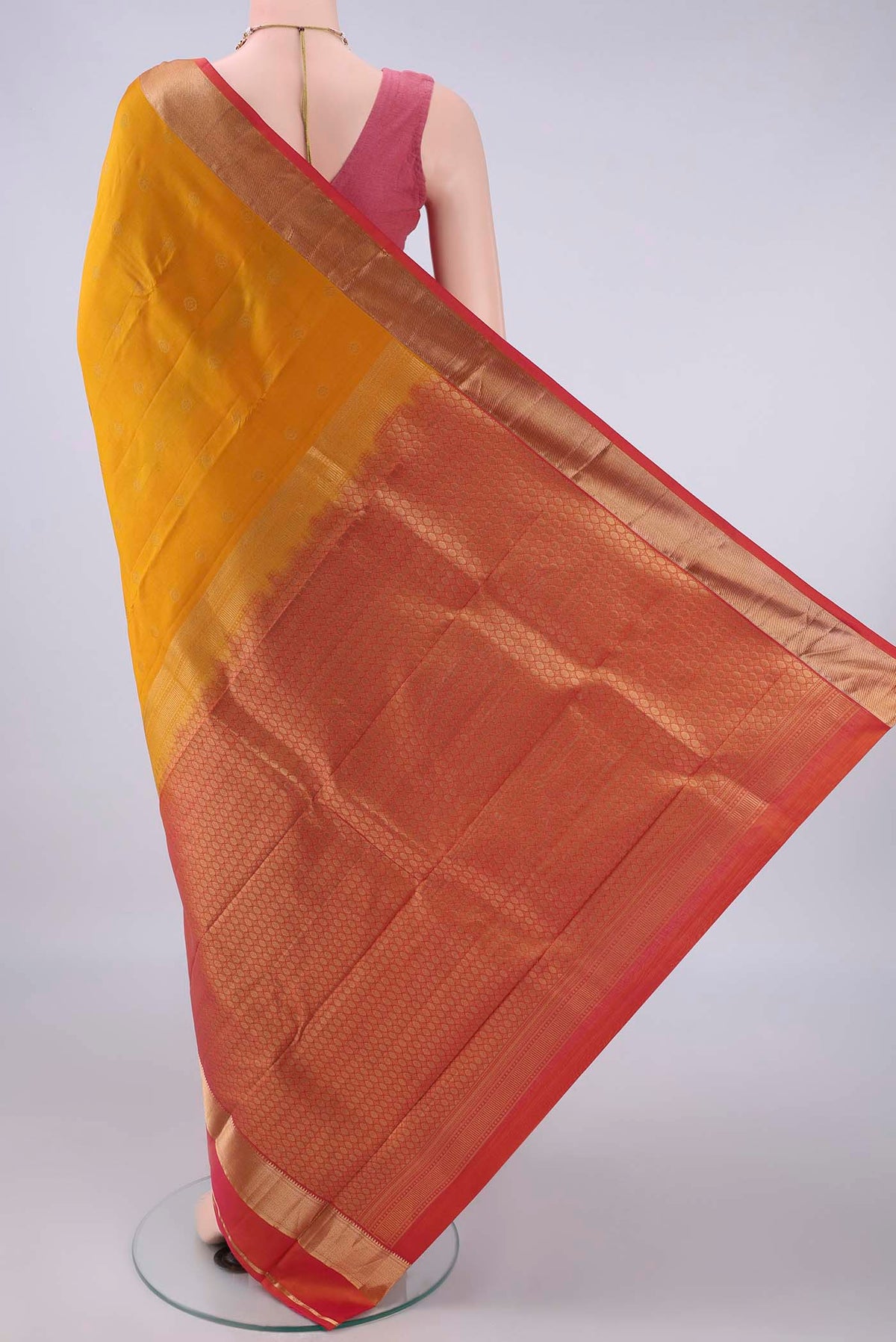 Flat view of Pure Silk Mustard Kanchipuram Saree with Zari Butta on the body and Zari Border. 