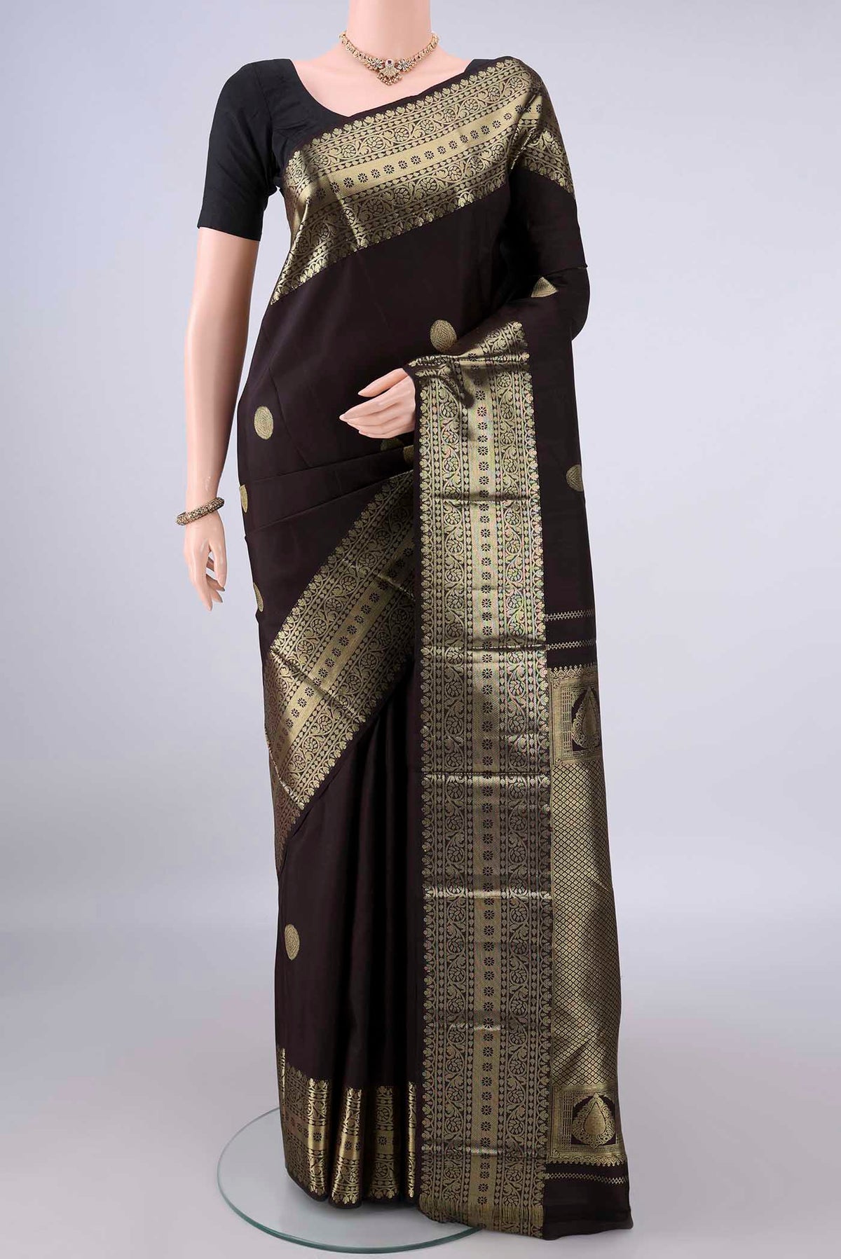 Pure Silk Coffee Brown Kanchipuram Saree with Zari Butta on the body and Zari Border.  displayed on a mannequin