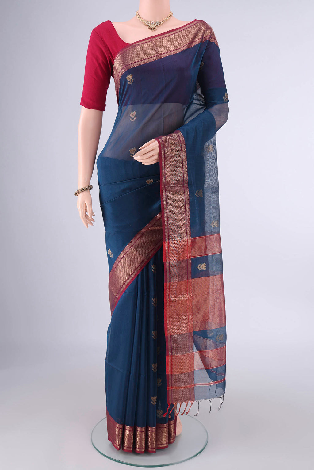 Maya Blue Maheshwari Cotton Saree with Zari Butta on the body and Zari Border.  displayed on a mannequin