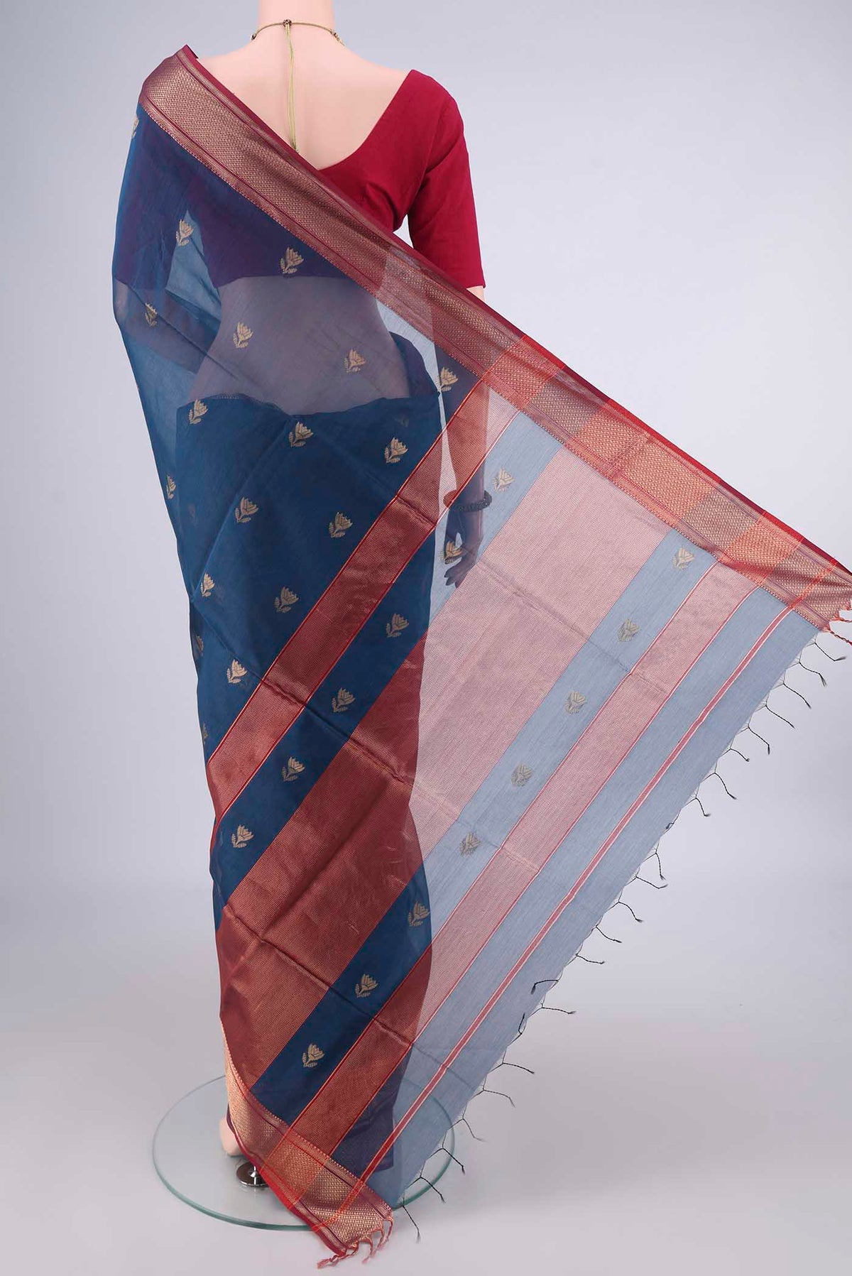 Flat view of Maya Blue Maheshwari Cotton Saree with Zari Butta on the body and Zari Border. 