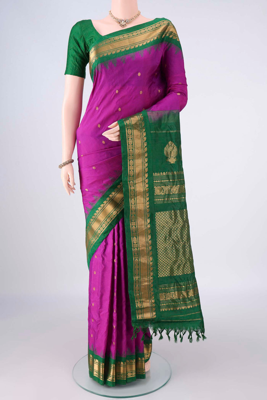 Pure Silk Magenta Gadwal Saree with Zari Butta on the body and Zari Border.  displayed on a mannequin