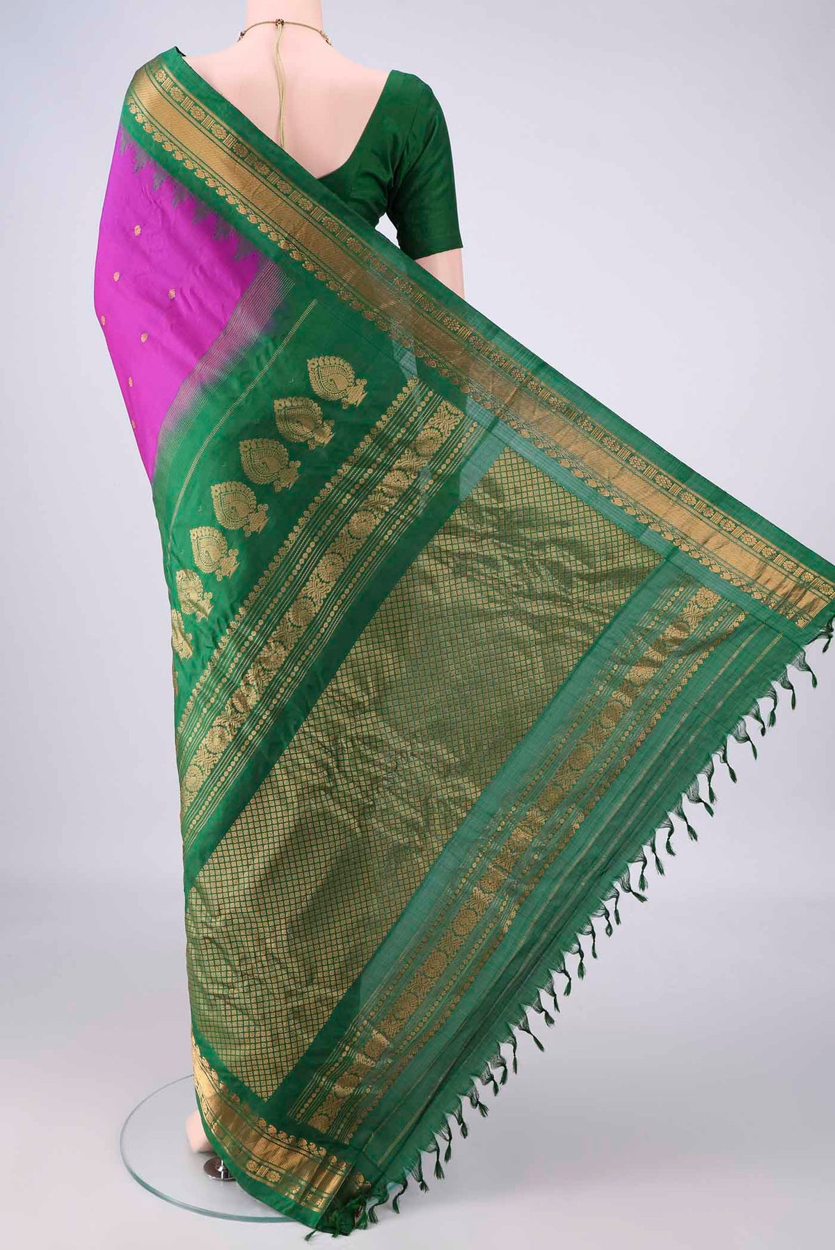 Flat view of Pure Silk Magenta Gadwal Saree with Zari Butta on the body and Zari Border. 