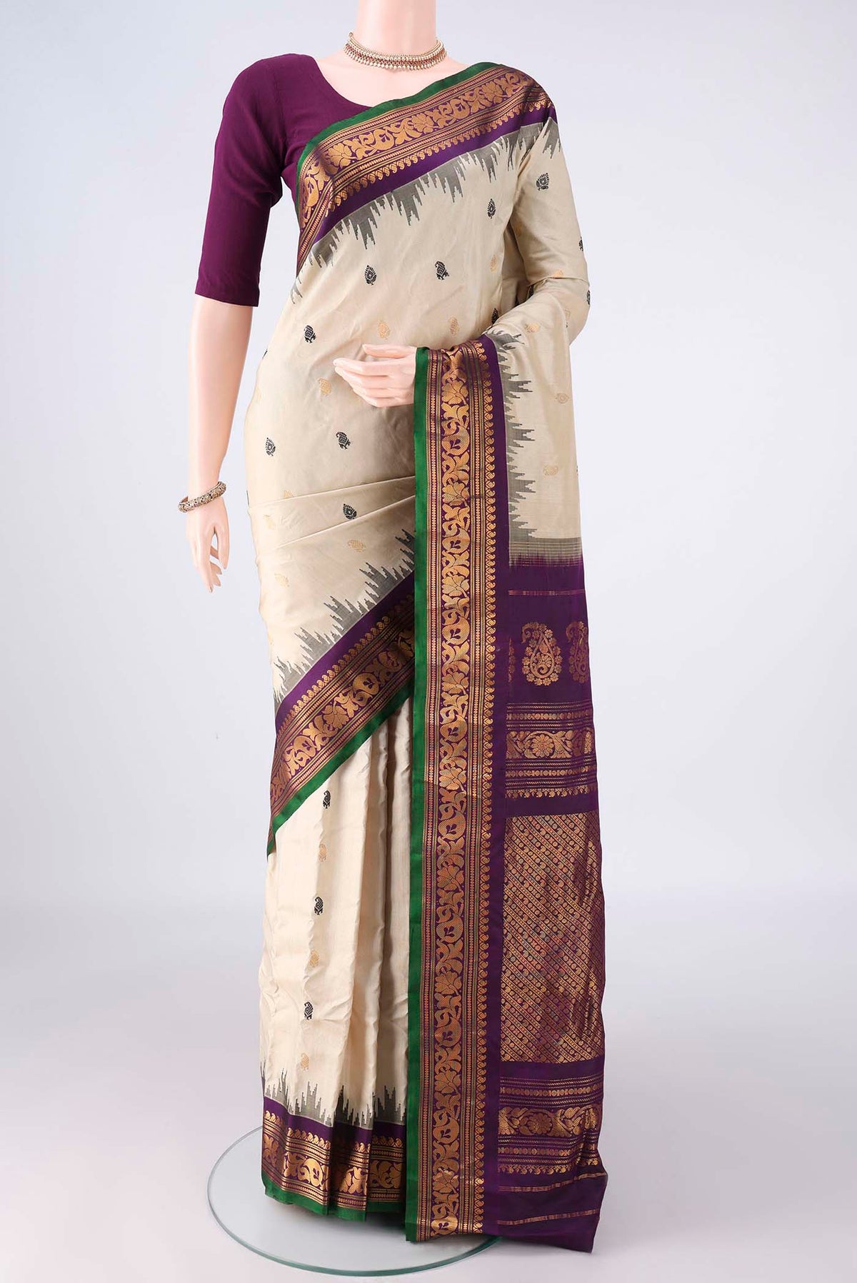 Pure Silk Off White Gadwal Saree with Thread Butta on the body and Zari Border.  displayed on a mannequin