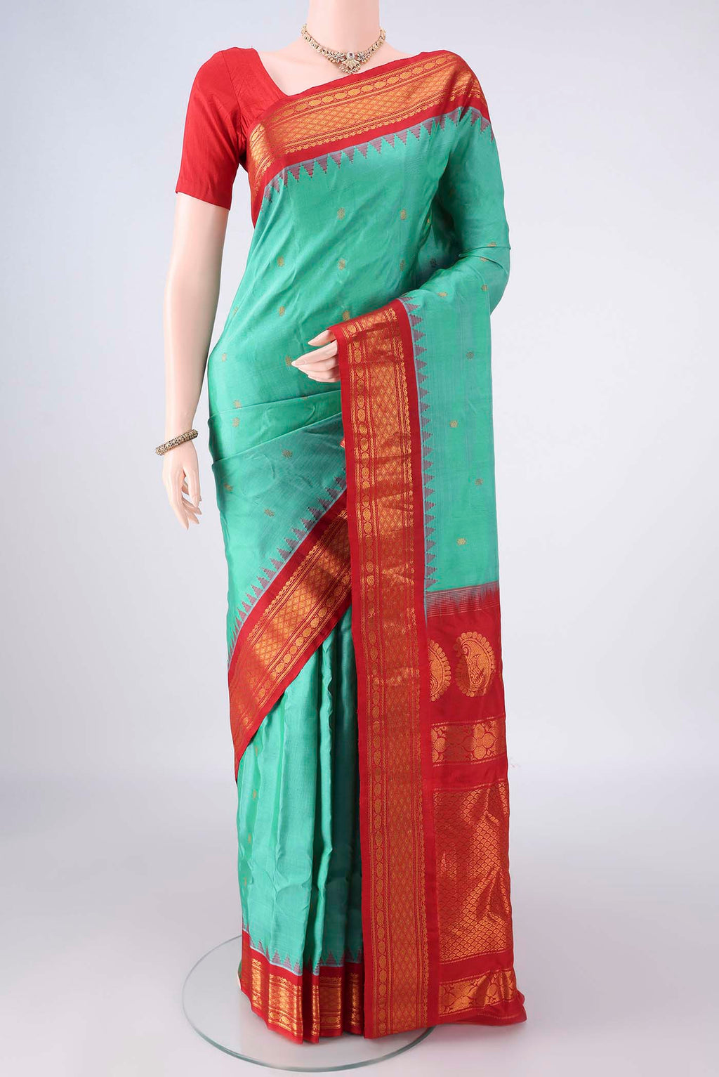 Pure Silk Sea Green Gadwal Saree with Zari Butta on the body and Zari Border.  displayed on a mannequin