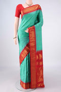 Pure Silk Sea Green Gadwal Saree with Zari Butta on the body and Zari Border.  displayed on a mannequin