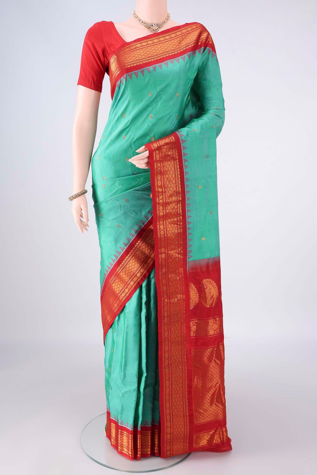 Pure Silk Sea Green Gadwal Saree with Zari Butta on the body and Zari Border.  displayed on a mannequin