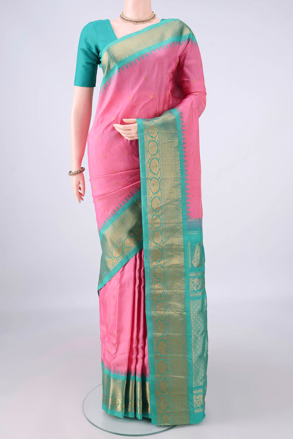 Rose pink Gadwal Cotton Saree with Zari Butta on the body and Zari Border.  displayed on a mannequin