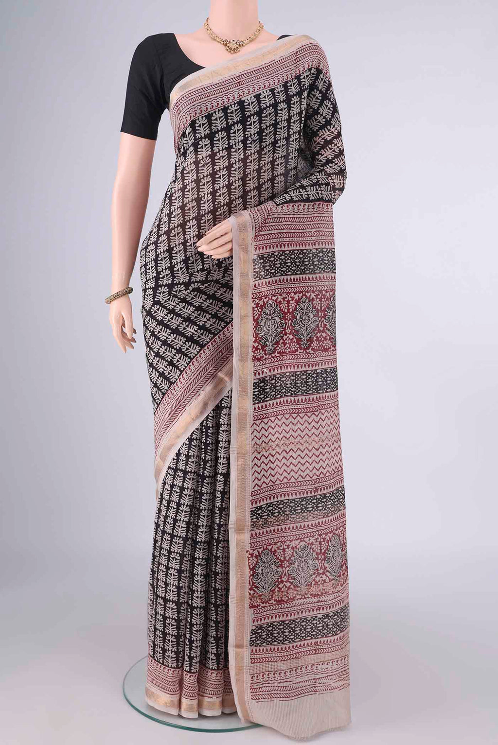 Black Maheshwari Cotton Saree with Printed design on the body and Zari Border.  displayed on a mannequin