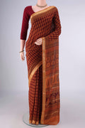 Maroon Maheshwari Cotton Saree with Printed design on the body and Zari Border.  displayed on a mannequin