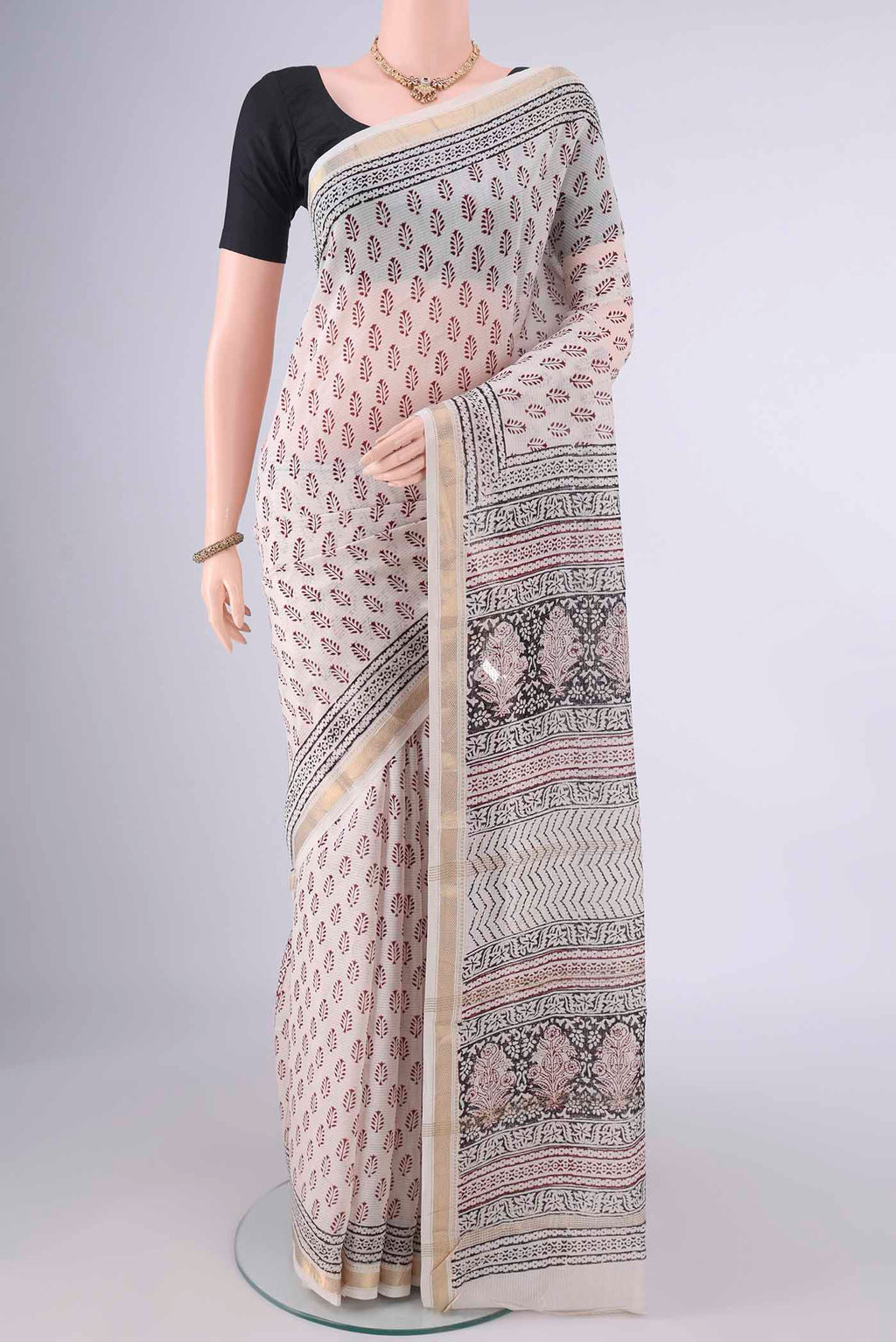 Off White Maheshwari Cotton Saree with Printed design on the body and Zari Border.  displayed on a mannequin