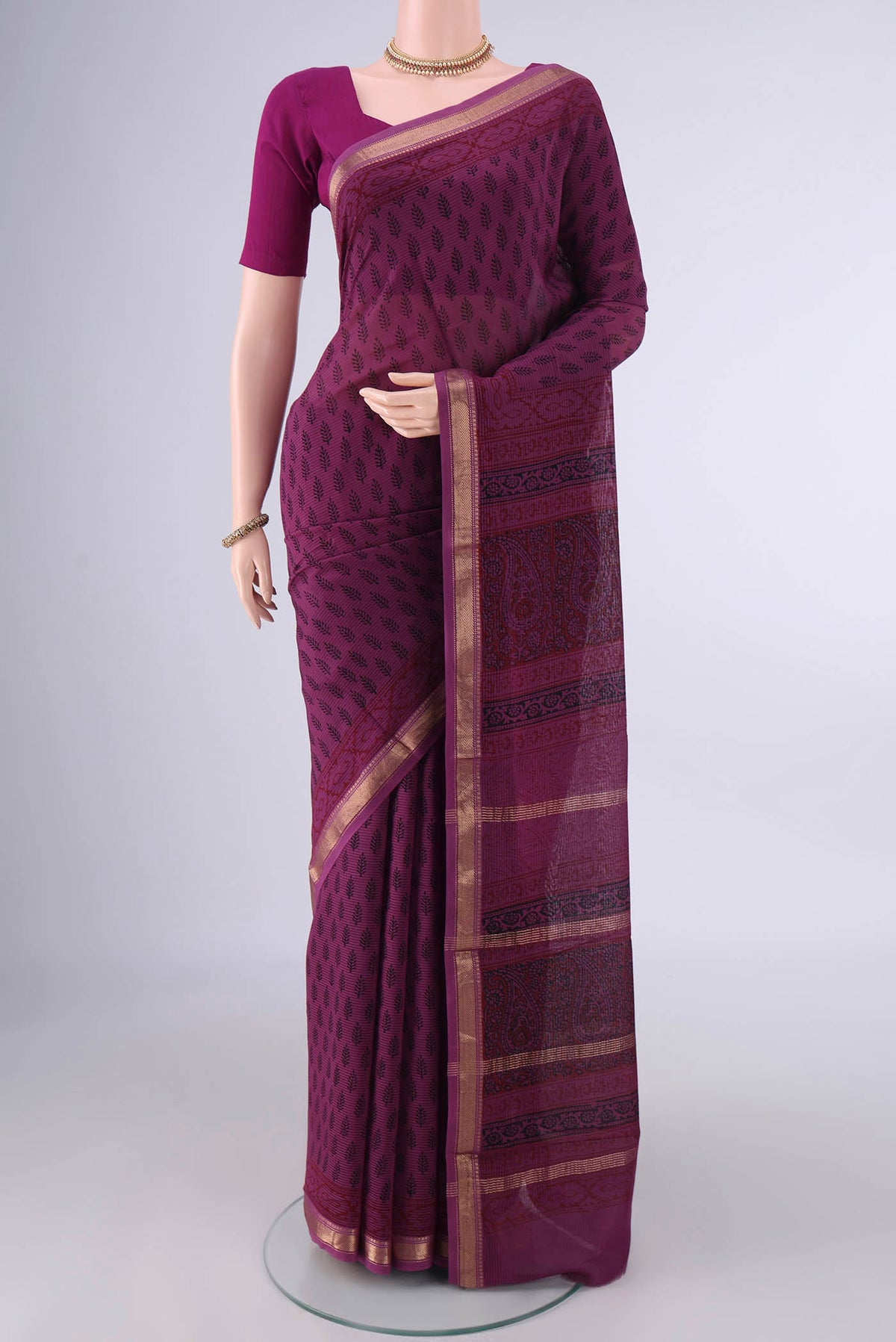 Mauve Maheshwari Cotton Saree with Printed design on the body and Zari Border.  displayed on a mannequin
