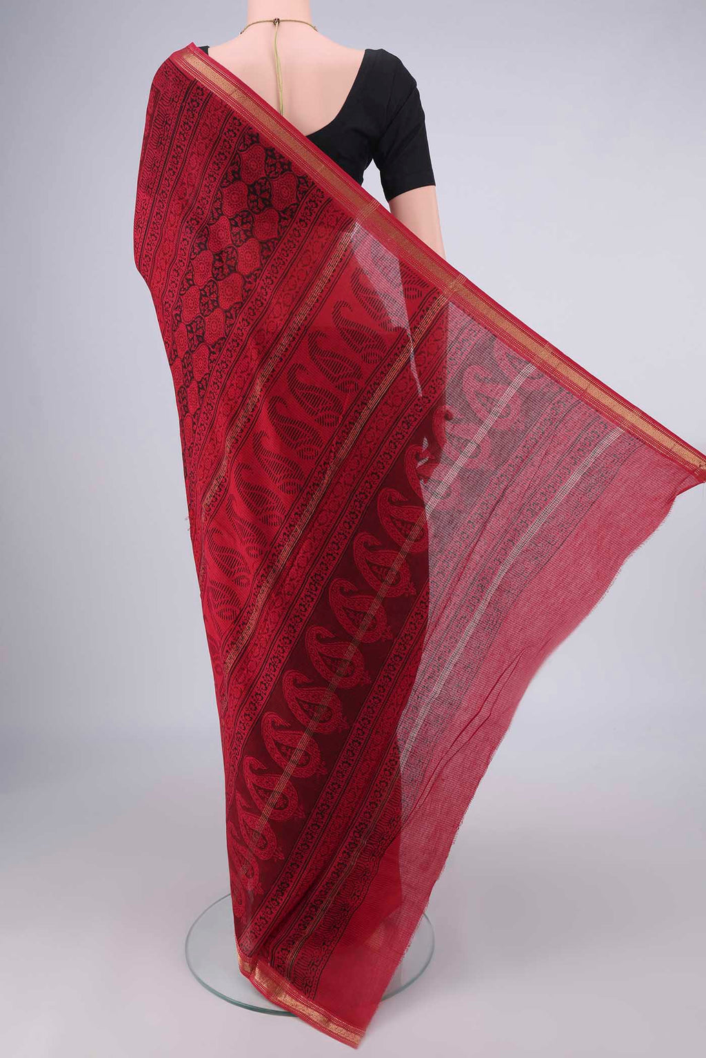 Flat view of Red Maheshwari Cotton Saree with Printed design on the body and Zari Border. 