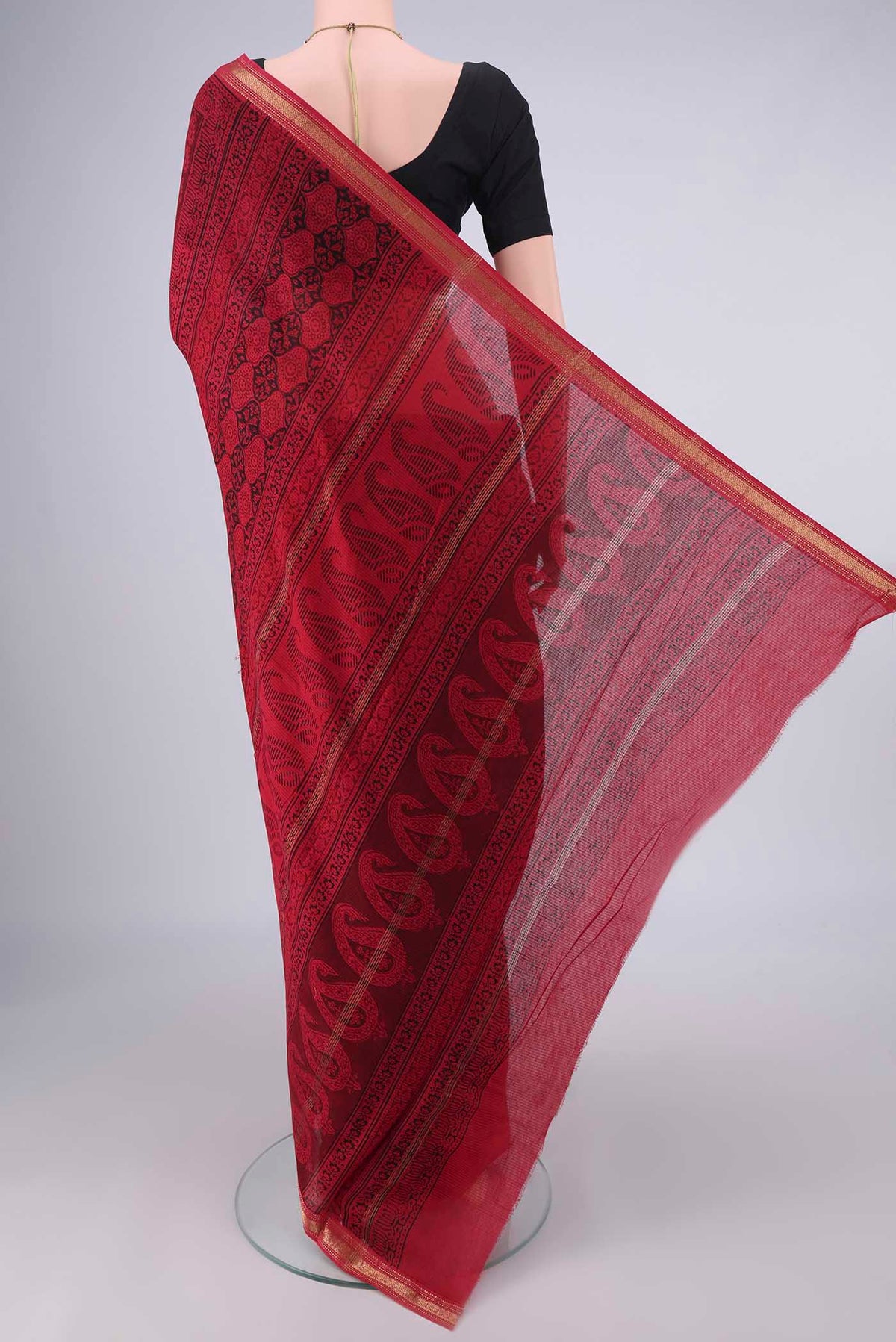 Flat view of Red Maheshwari Cotton Saree with Printed design on the body and Zari Border. 