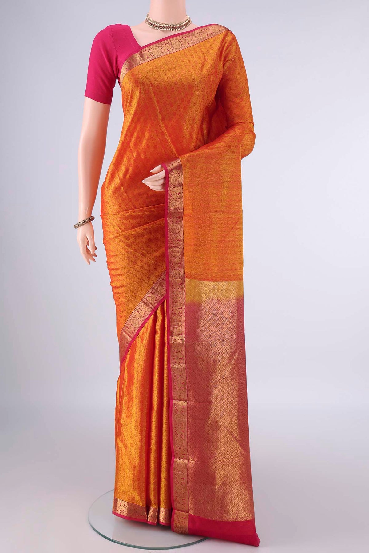 Pure Silk Mustard Kanjivaram Saree with Jacquard design on the body and Zari Border.  displayed on a mannequin
