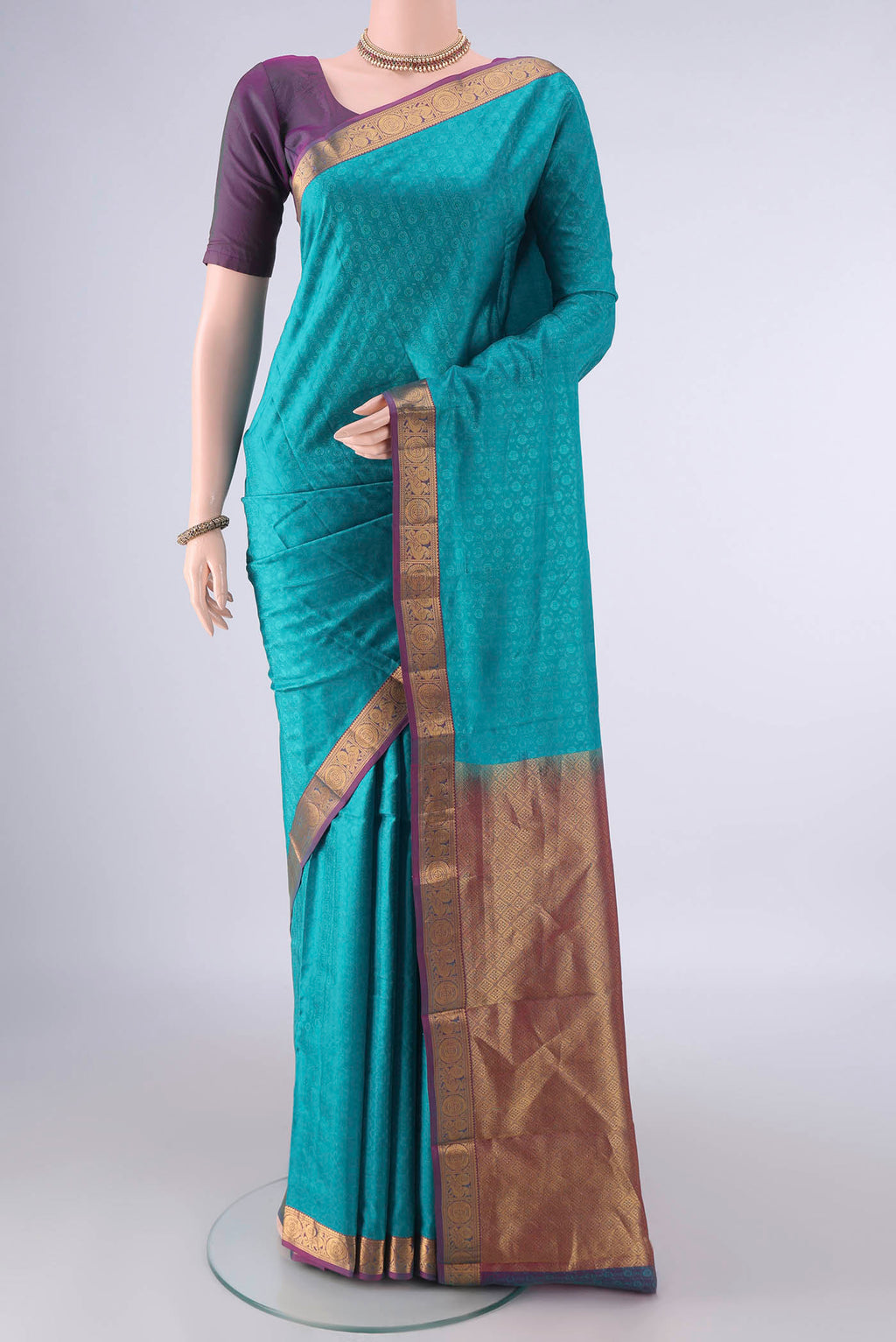 Pure Silk Turquoise Kanjivaram Saree with Jacquard design on the body and Zari Border.  displayed on a mannequin