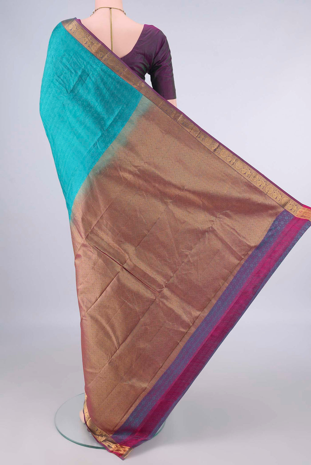 Flat view of Pure Silk Turquoise Kanjivaram Saree with Jacquard design on the body and Zari Border. 