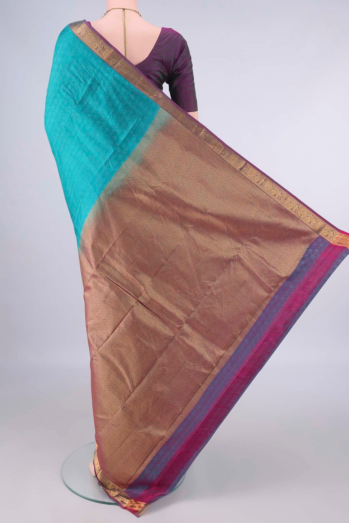Flat view of Pure Silk Turquoise Kanjivaram Saree with Jacquard design on the body and Zari Border. 