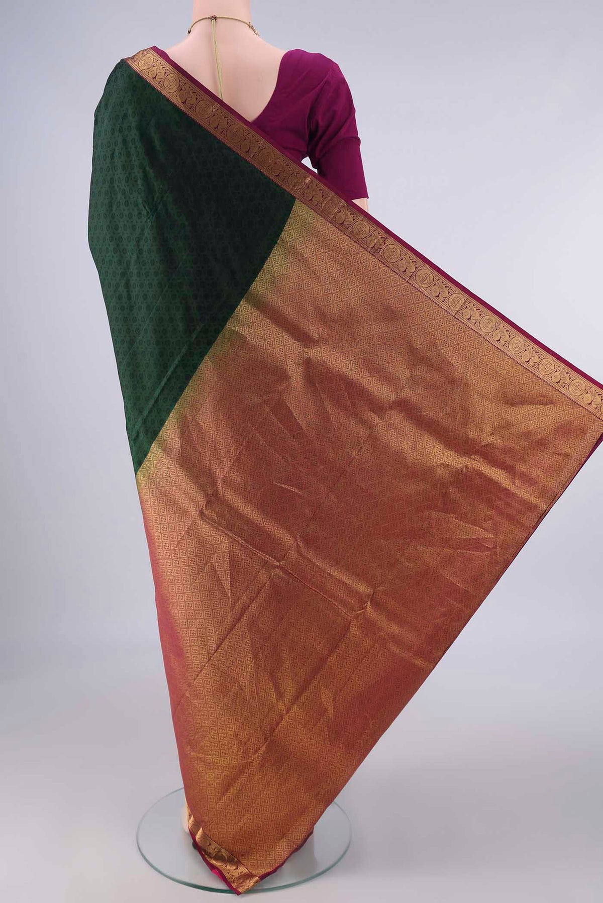 Flat view of Pure Silk Bottle Green Kanjivaram Saree with Jacquard design on the body and Zari Border. 