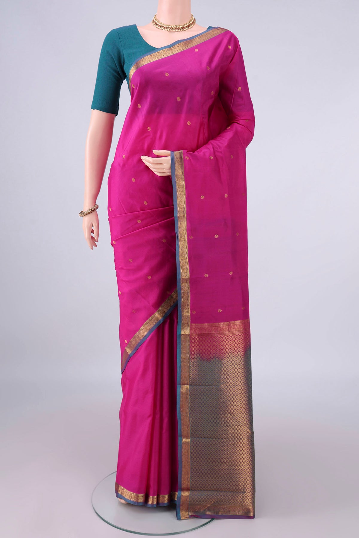 Pure Silk Rani Pink Kanjivaram Saree with Zari Butta on the body and Ganga Jamuna Border.  displayed on a mannequin