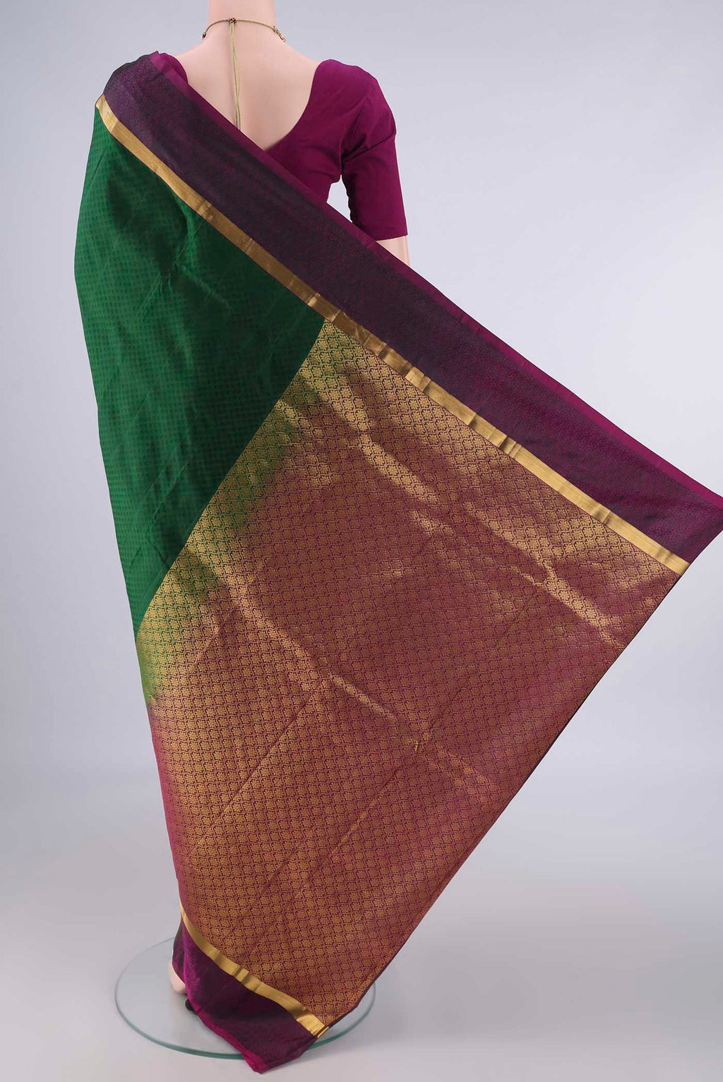 Flat view of Pure Silk Bottle Green Kanjivaram Saree with Jacquard design on the body and Zari Border. 