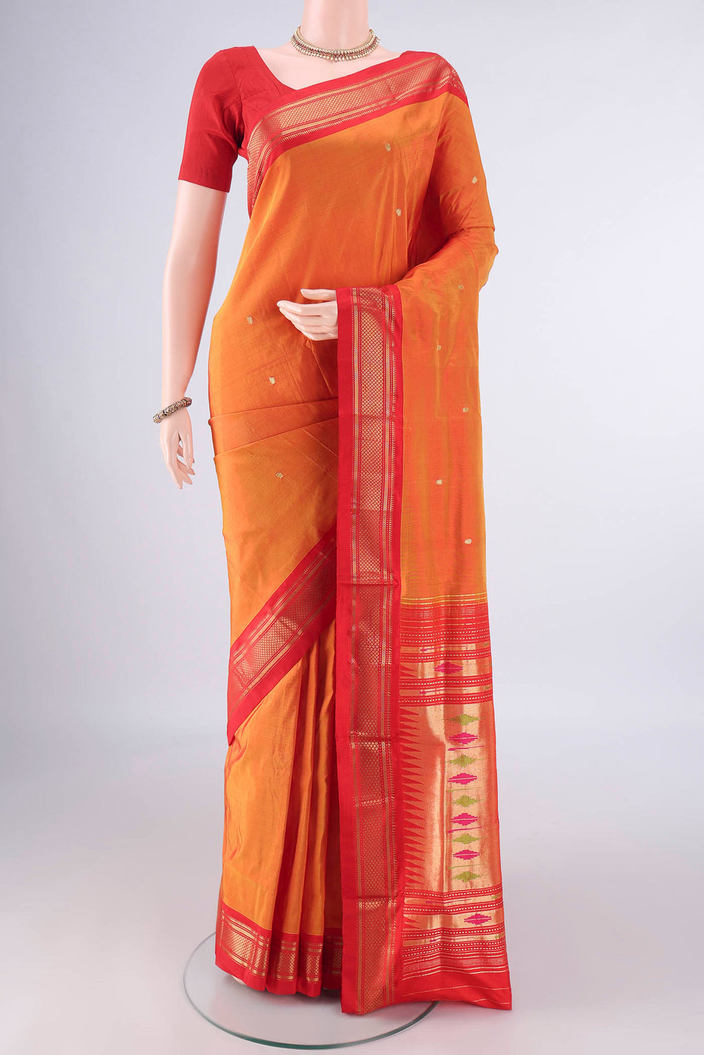 Pure Silk Brick Orange Paithani Saree with Zari Butta on the body and Zari Border.  displayed on a mannequin