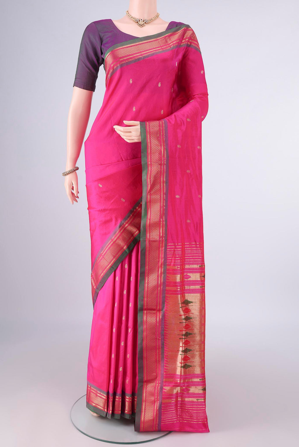 Pure Silk Rani Pink Paithani Saree with Zari Butta on the body and Zari Border.  displayed on a mannequin