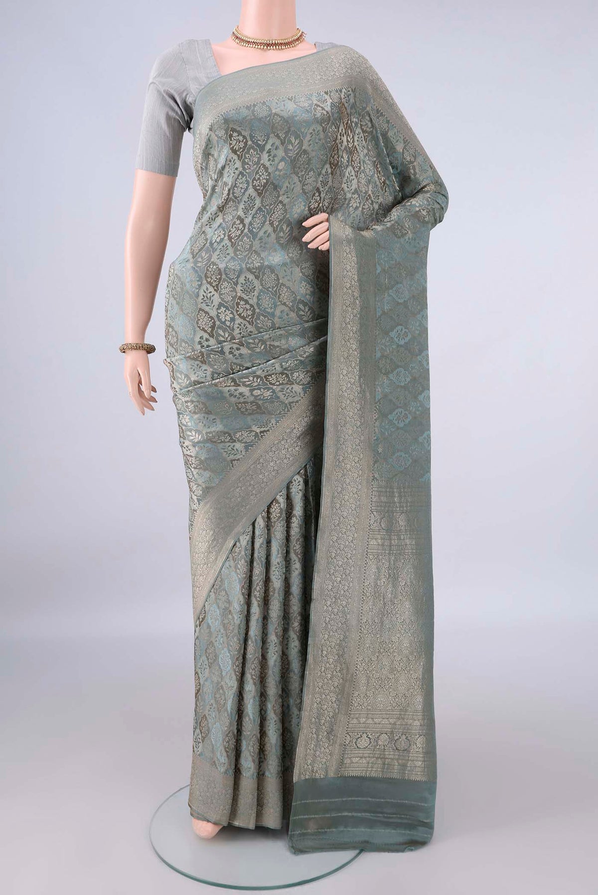 Grey Mysore Crepe Saree with Zari Brocade on the body and Zari Border.  displayed on a mannequin