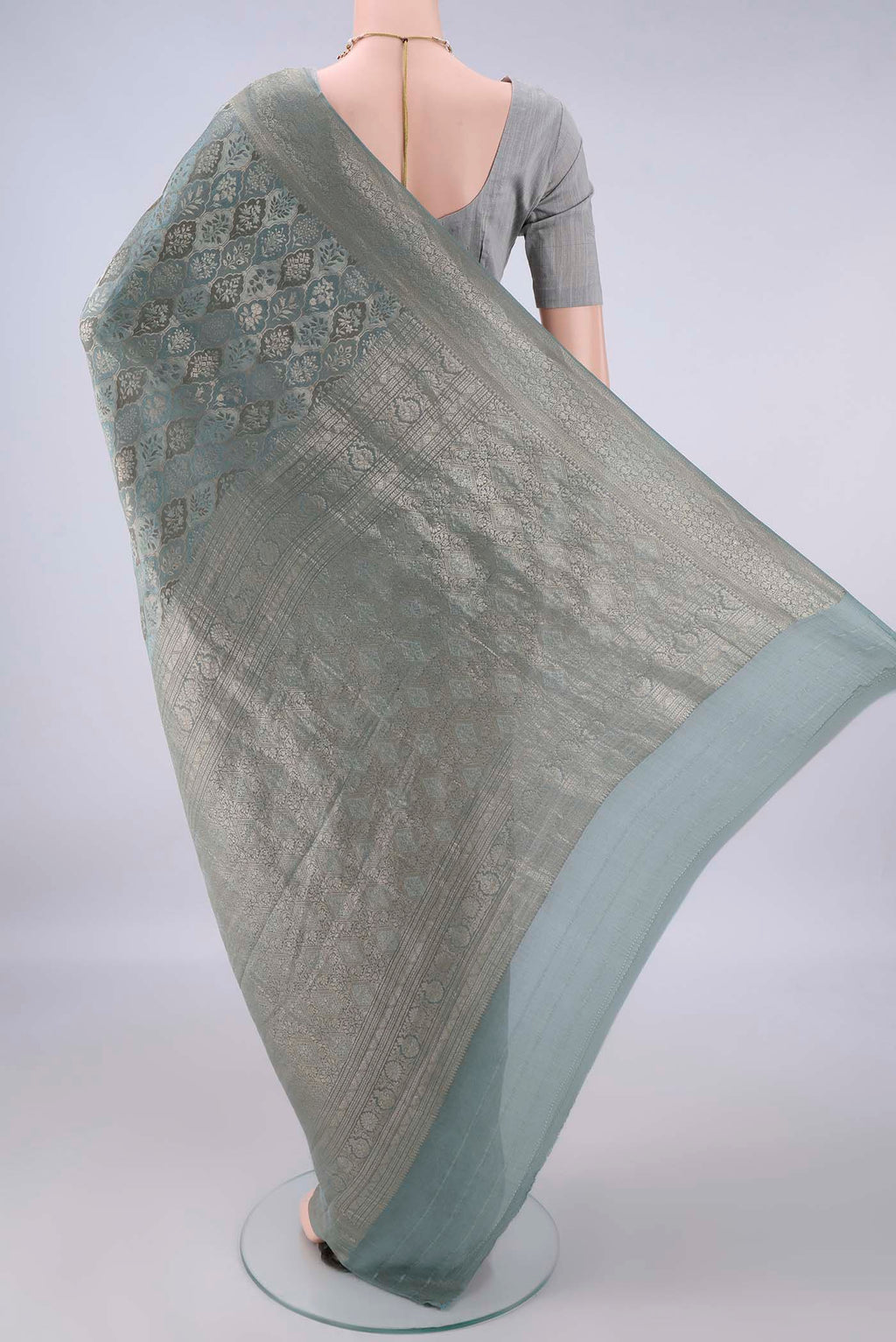 Flat view of Grey Mysore Crepe Saree with Zari Brocade on the body and Zari Border. 
