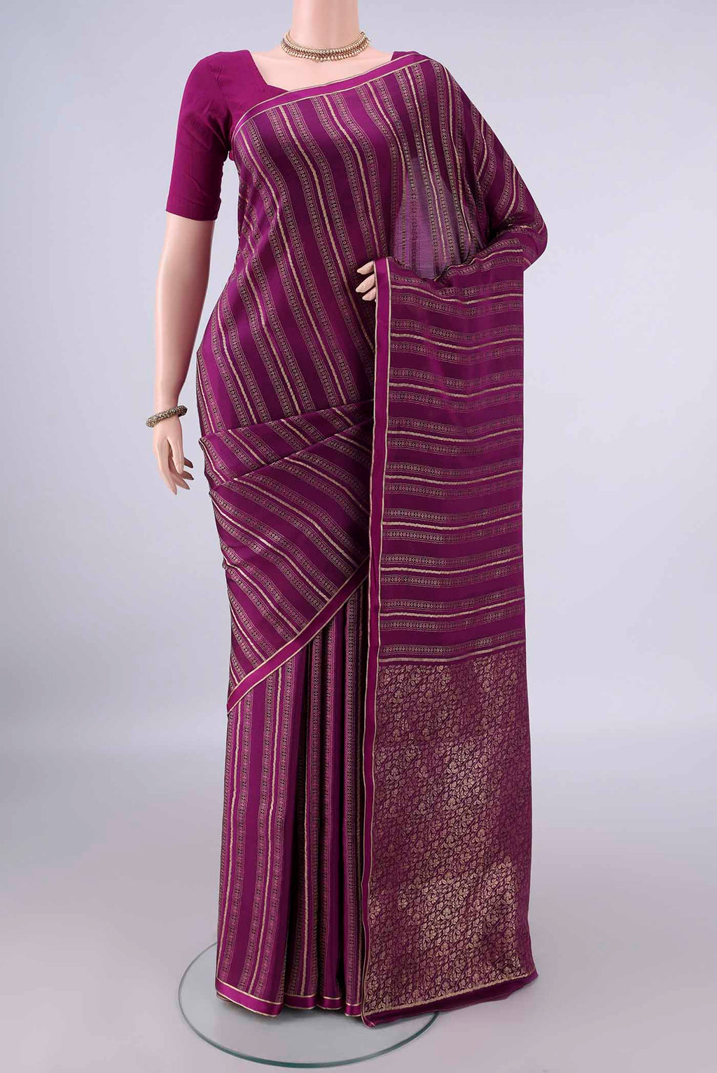 Magenta Mysore Crepe Saree with Stripes on the body and Zari Border.  displayed on a mannequin