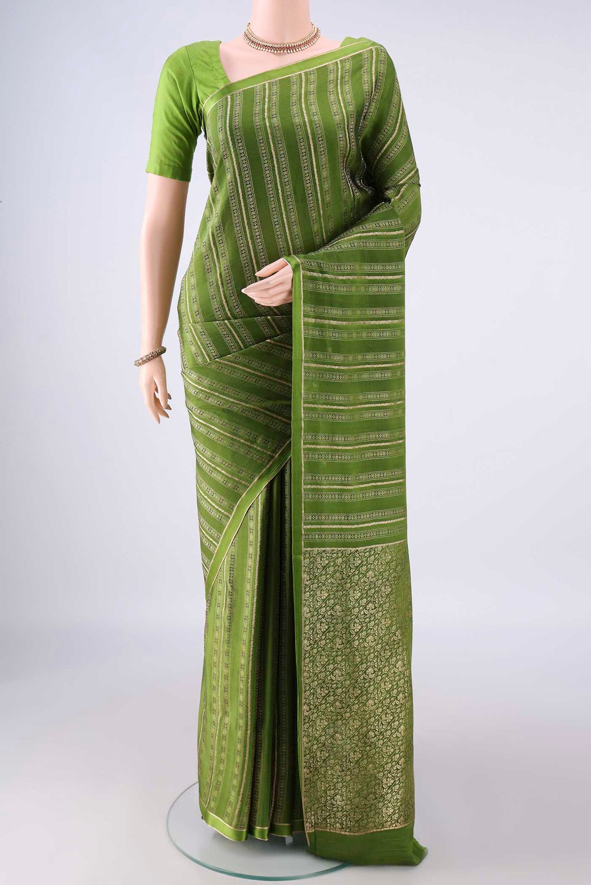 Mehandi Green Mysore Crepe Saree with Stripes on the body and Zari Border.  displayed on a mannequin