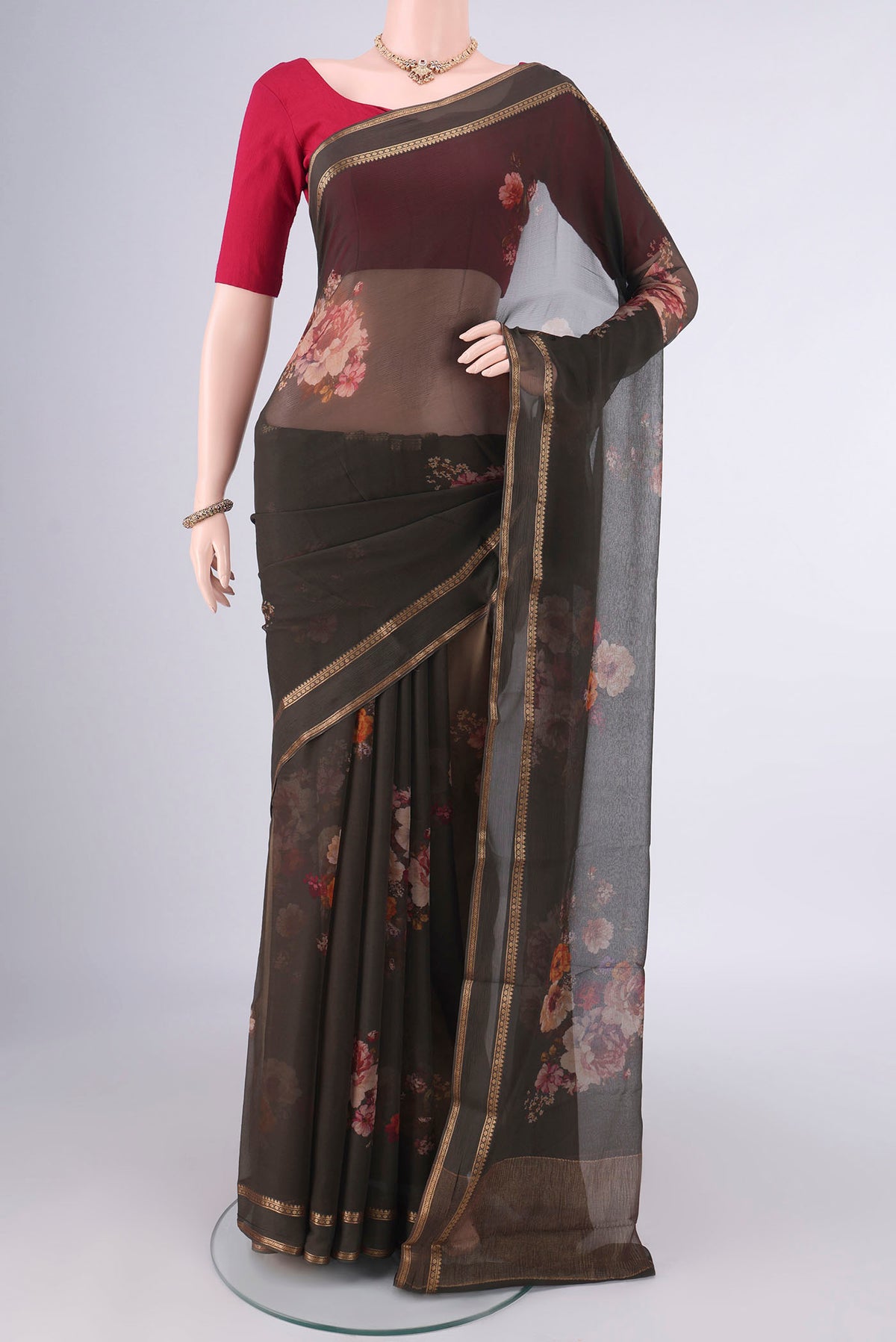 Olive Green Mysore Chiffon Saree with Printed design on the body and Zari Border.  displayed on a mannequin