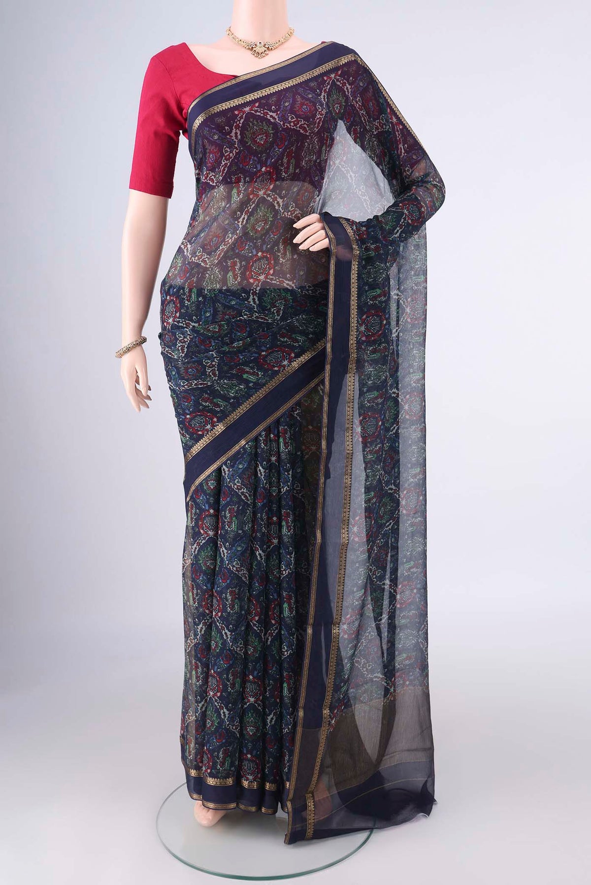 Navy Blue Mysore Chiffon Saree with Printed design on the body and Zari Border.  displayed on a mannequin