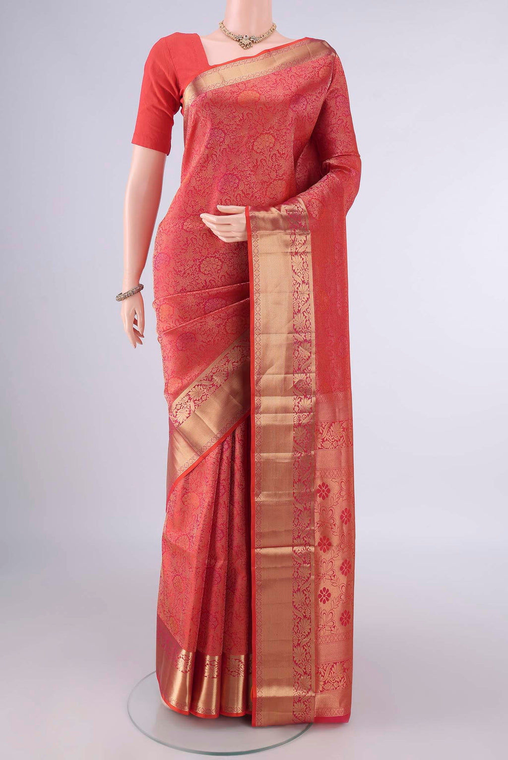 Pure Silk Brick Orange Soft Saree with Zari Brocade on the body and Zari Border.  displayed on a mannequin