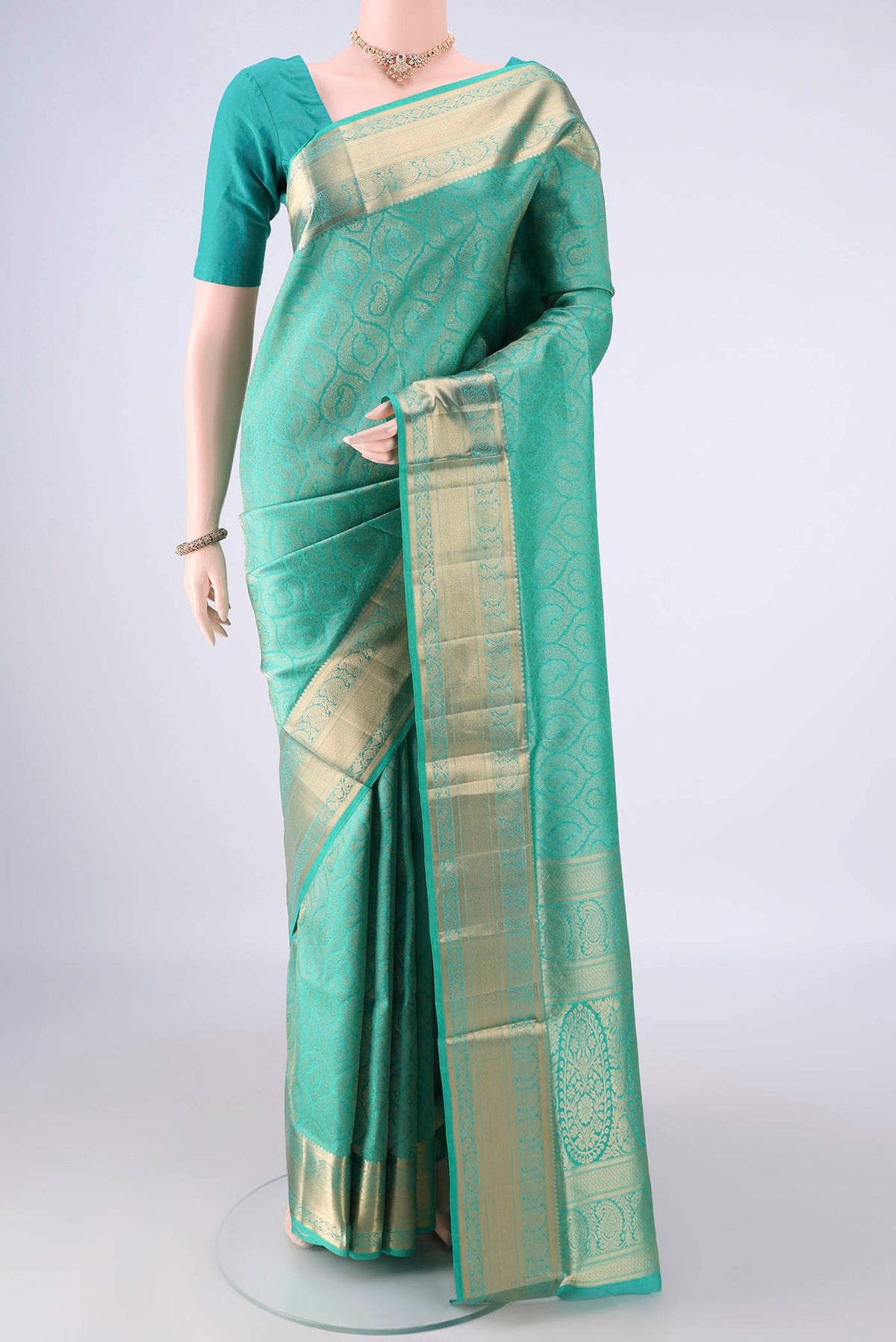 Pure Silk Sea Green Soft Saree with Zari Brocade on the body and Zari Border.  displayed on a mannequin