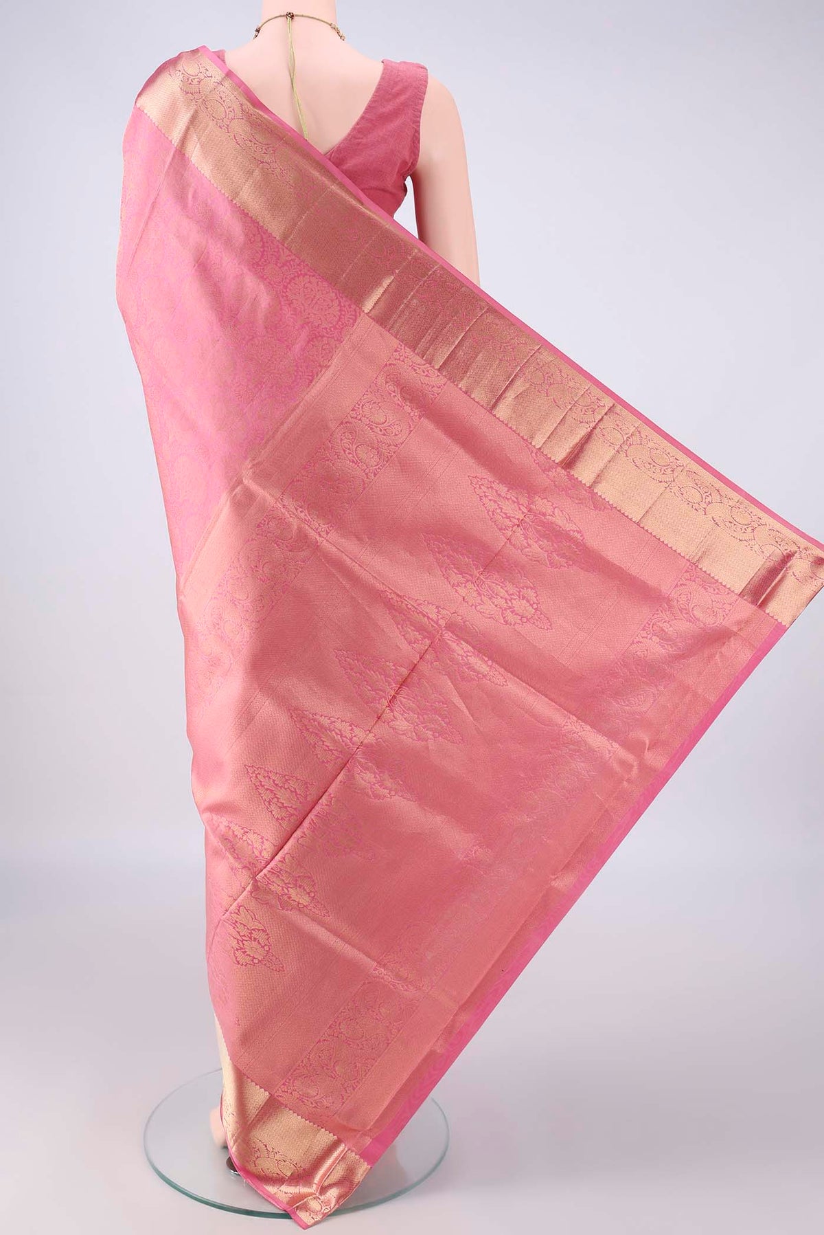 Flat view of Pure Silk Pink Soft Saree with Zari Brocade on the body and Zari Border. 