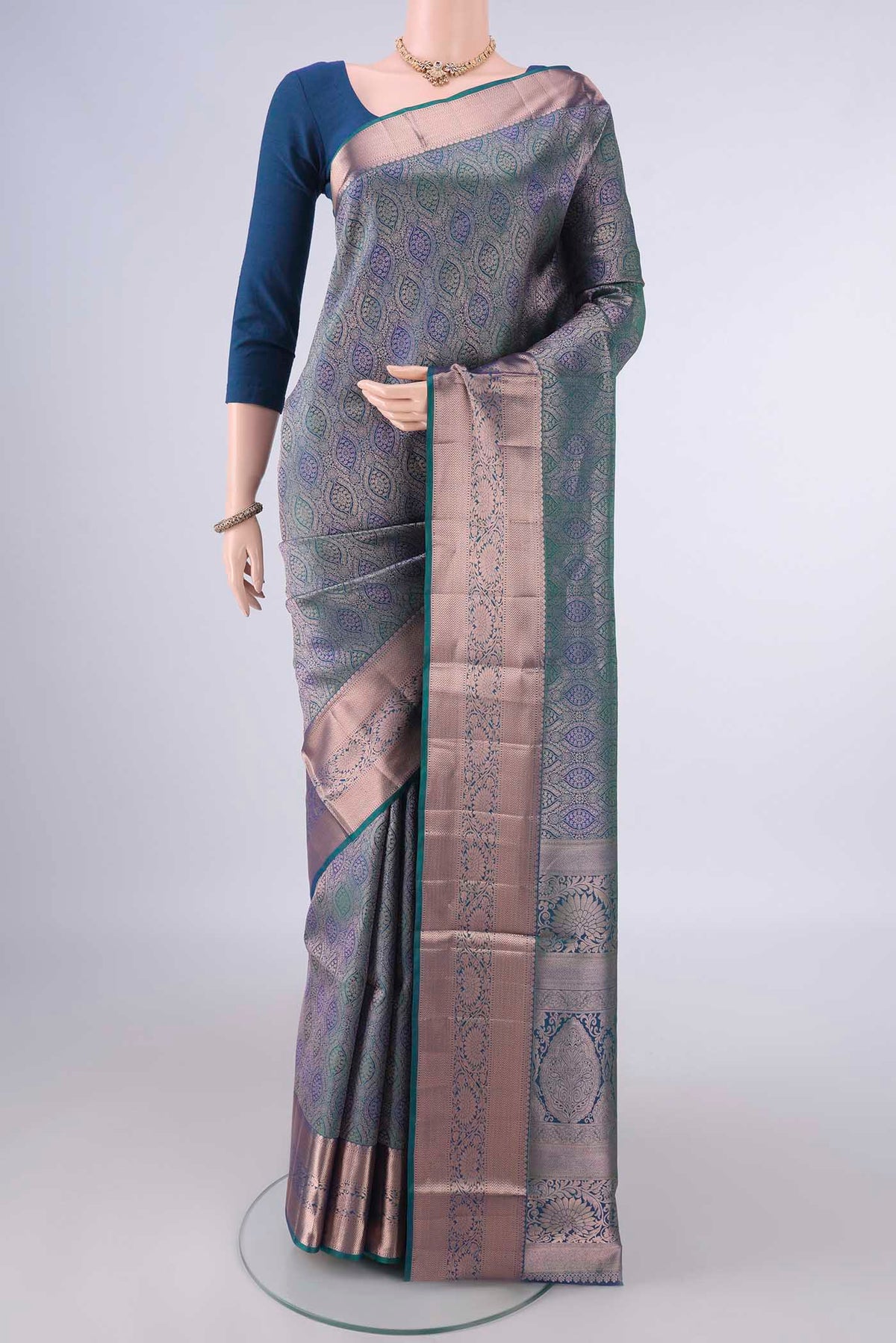 Pure Silk Peacock Blue Dual Tone Soft Saree with Zari Brocade on the body and Zari Border.  displayed on a mannequin