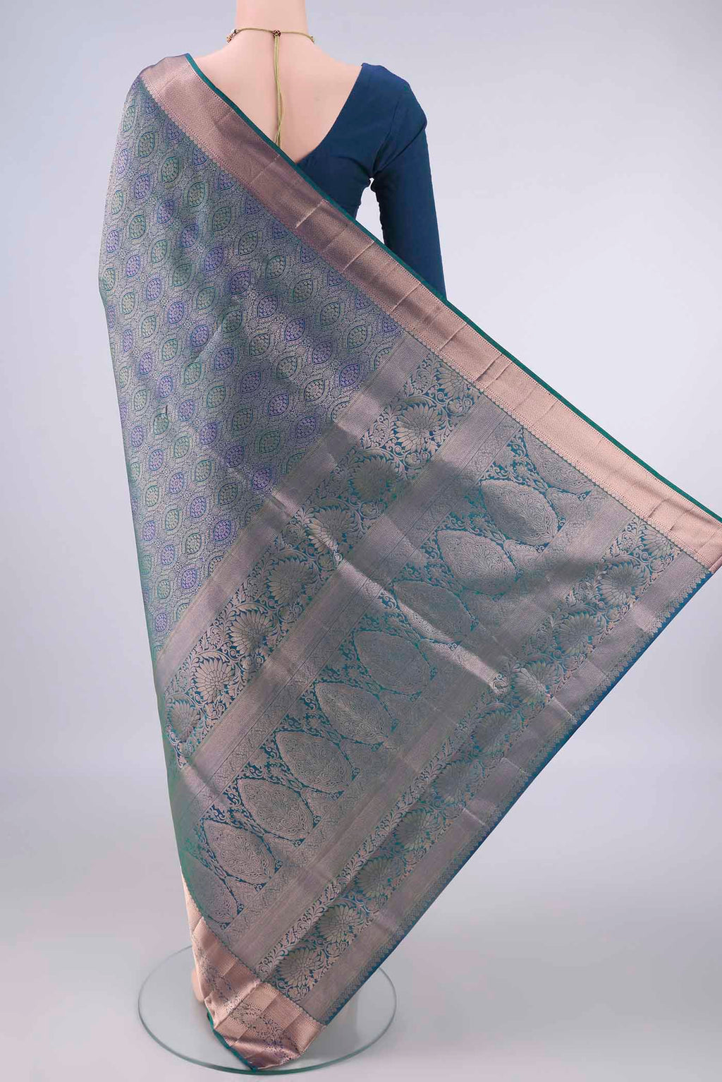 Flat view of Pure Silk Peacock Blue Dual Tone Soft Saree with Zari Brocade on the body and Zari Border. 