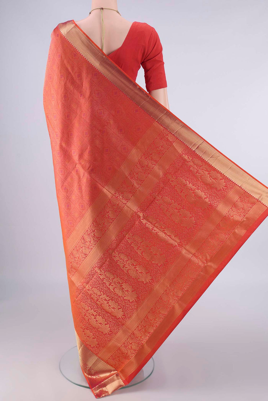 Flat view of Pure Silk Brick Orange Soft Saree with Zari Brocade on the body and Zari Border. 