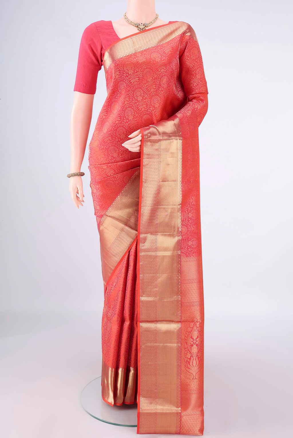 Pure Silk Brick Orange Soft Saree with Zari Brocade on the body and Zari Border.  displayed on a mannequin