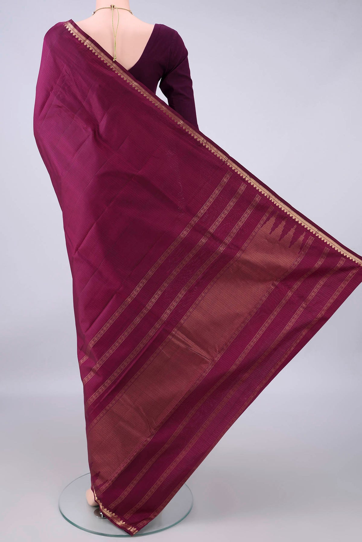 Flat view of Pure Silk Maroon Kanjivaram Saree with Plain Body and Zari Border. 