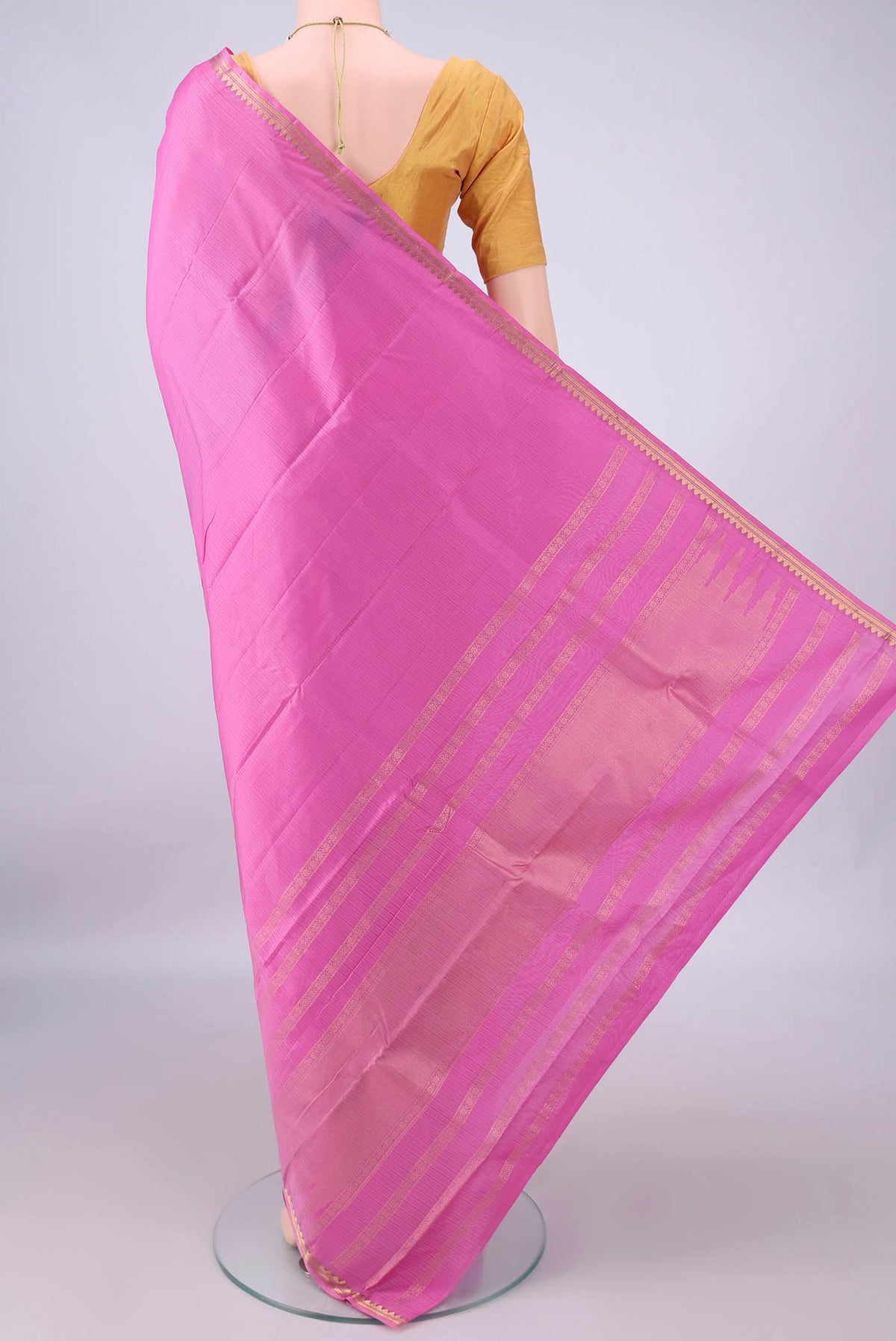 Flat view of Pure Silk Pink Kanjivaram Saree with Plain Body and Zari Border. 