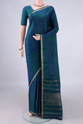 Pure Silk Peacock Blue Kanjivaram Saree with Zari Butta on the body and Zari Border.  displayed on a mannequin