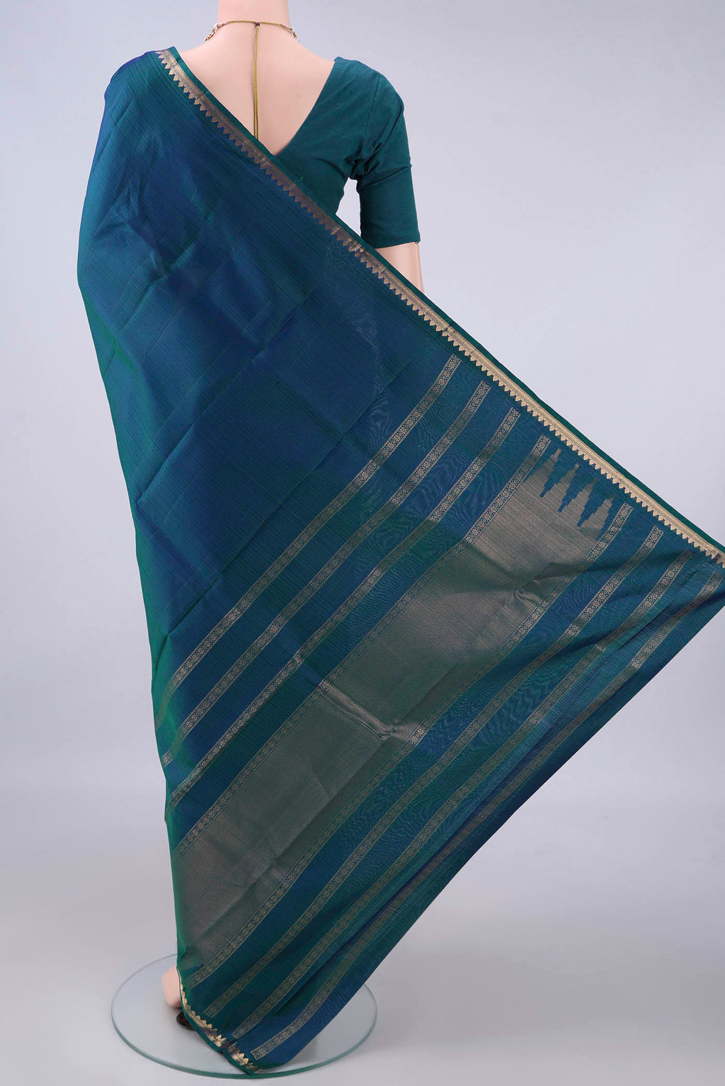 Flat view of Pure Silk Peacock Blue Kanjivaram Saree with Zari Butta on the body and Zari Border. 
