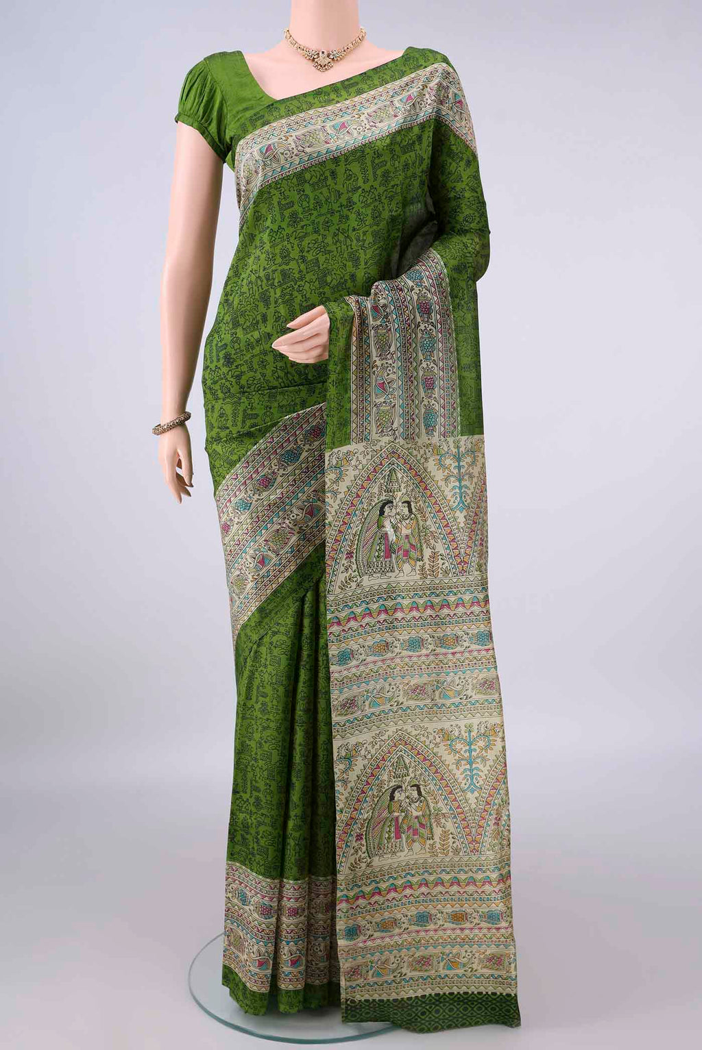 Pure Silk Green Printed Saree with Printed design on the body and Printed Border.  displayed on a mannequin