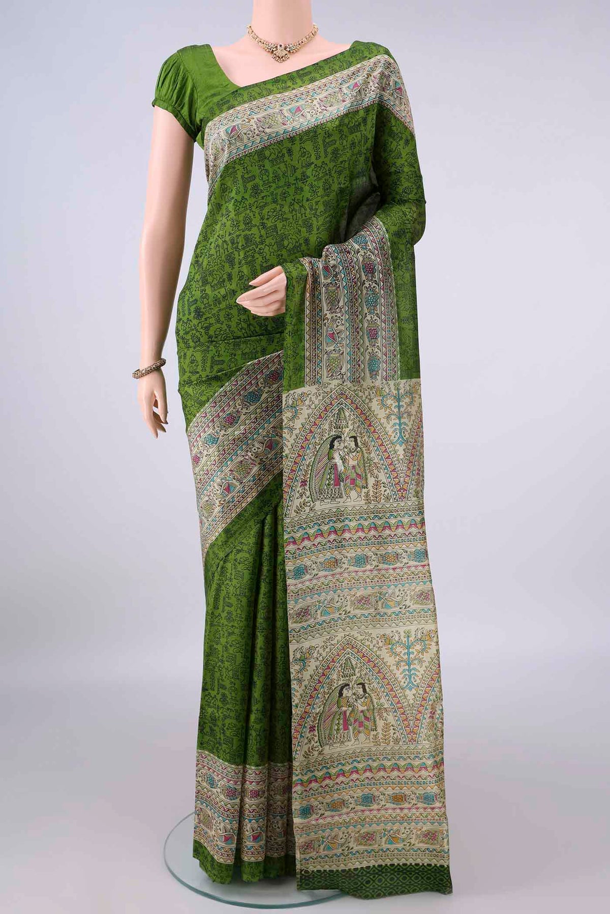 Pure Silk Green Printed Saree with Printed design on the body and Printed Border.  displayed on a mannequin