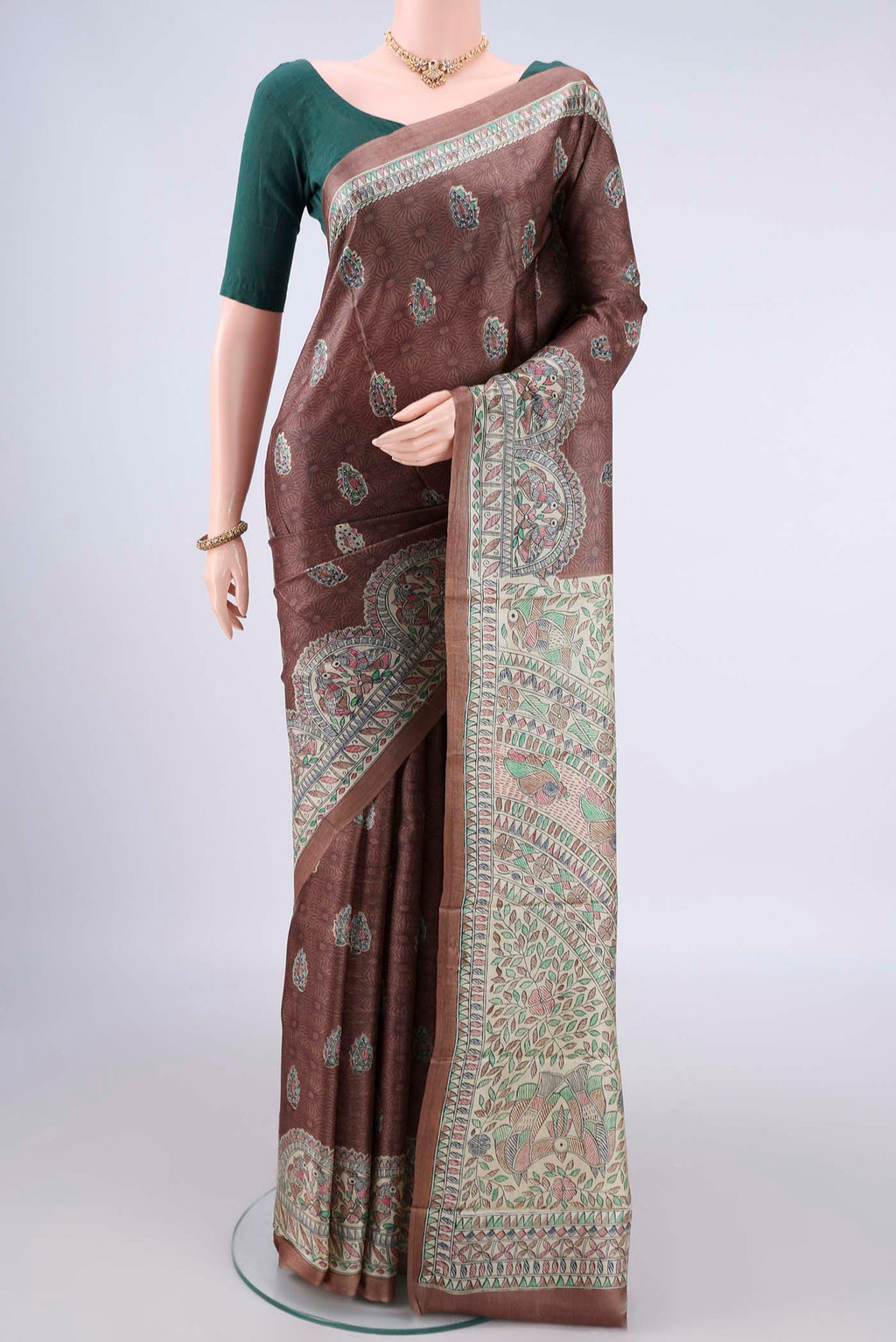 Brown Tussar Saree with Printed design on the body and Printed Border.  displayed on a mannequin