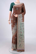 Brown Tussar Saree with Printed design on the body and Printed Border.  displayed on a mannequin