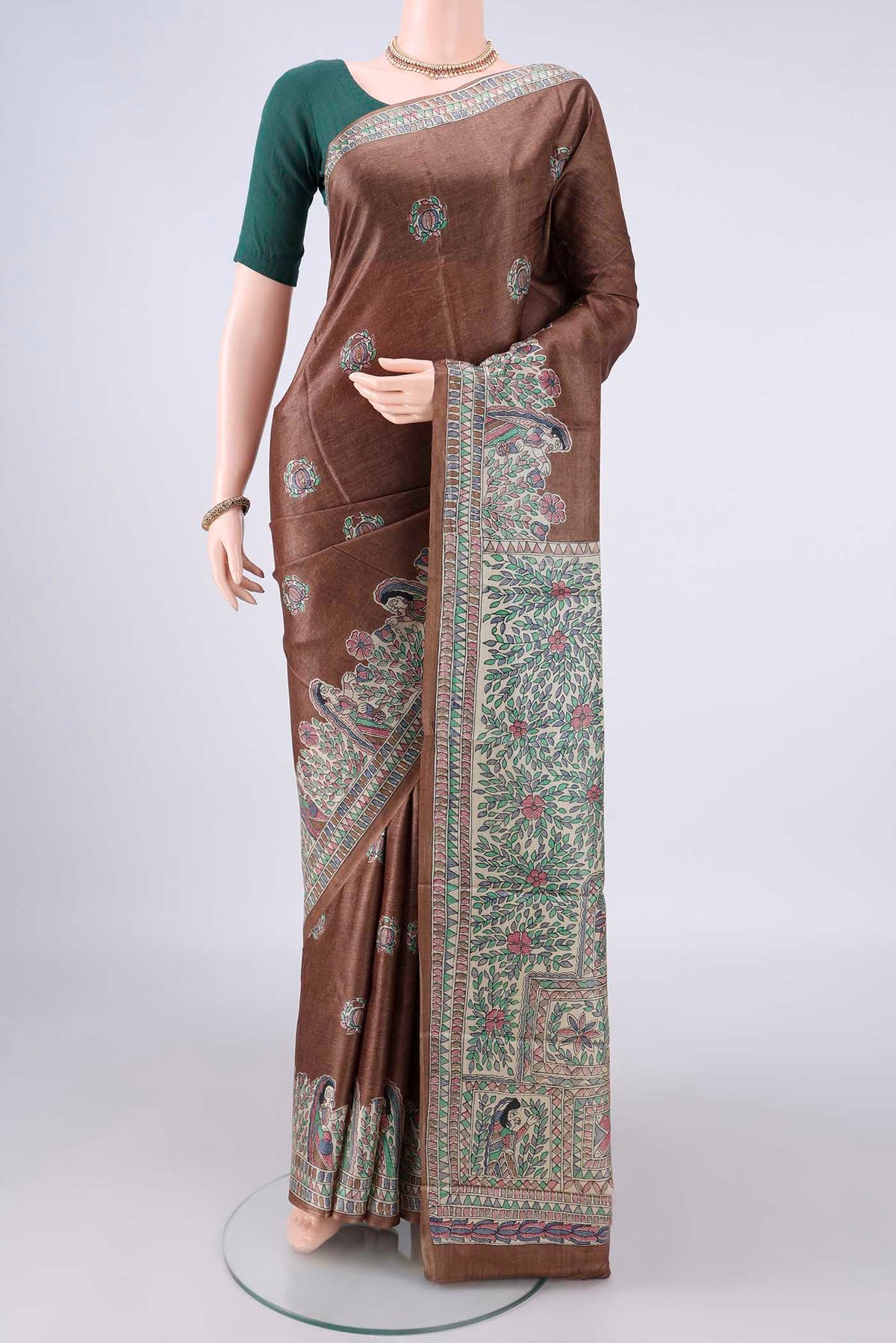 Brown Tussar Saree with Printed design on the body and Printed Border.  displayed on a mannequin