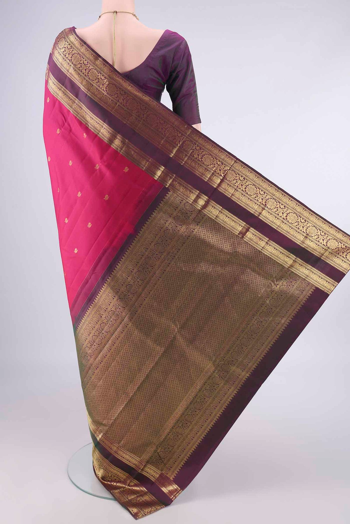 Flat view of Pure Silk Rani Pink Kanchipuram Saree with Zari Butta on the body and Zari Border. 