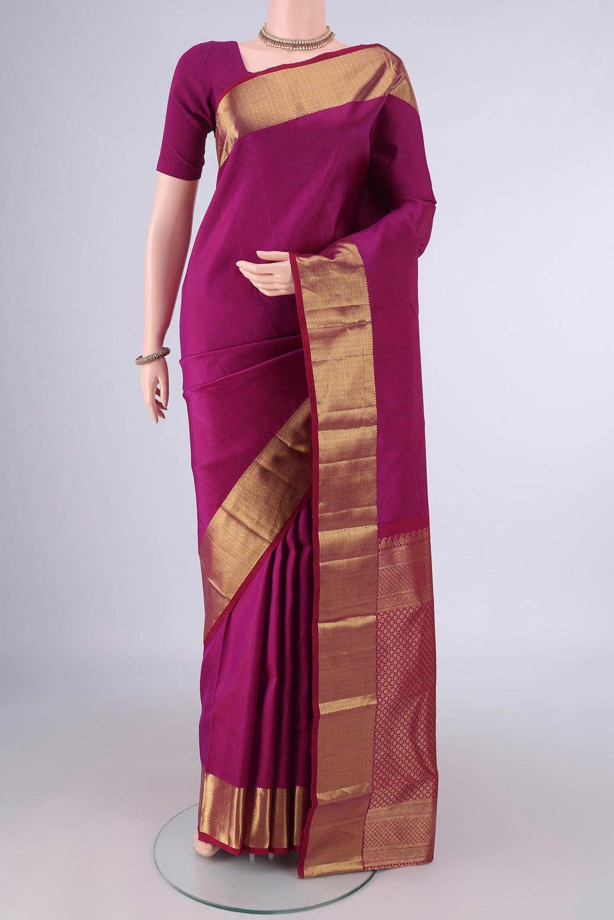 Pure Silk Magenta Kanjivaram Saree with Jacquard design on the body and Zari Border.  displayed on a mannequin